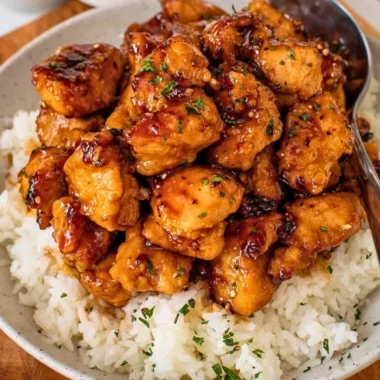 Honey Garlic Chicken Bites served on a plate with a side of vegetables