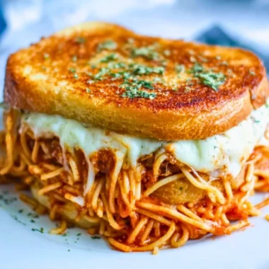 Delicious spaghetti grilled cheese sandwich served with marinara sauce