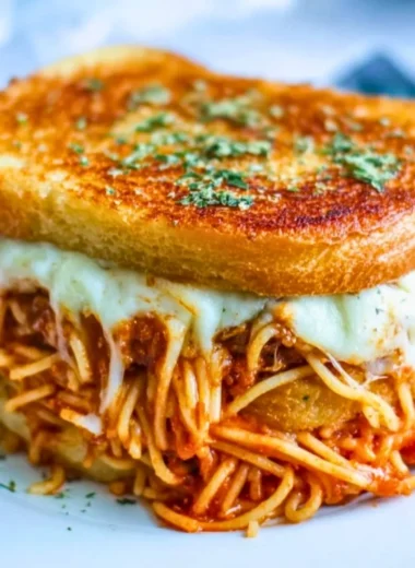 Delicious spaghetti grilled cheese sandwich served with marinara sauce