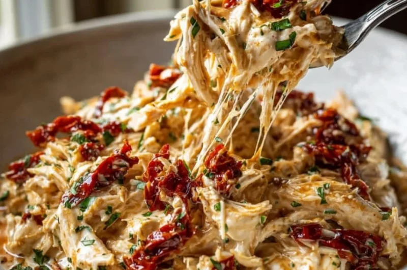 Crockpot Marry Me Chicken served in a bowl with creamy sauce and herbs