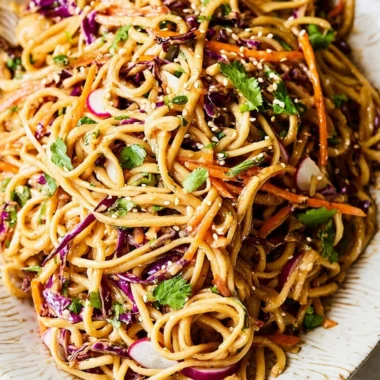 Asian noodle salad with colorful vegetables in peanut dressing