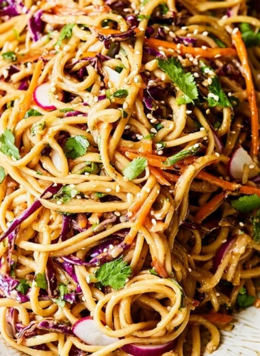 Asian noodle salad with colorful vegetables in peanut dressing