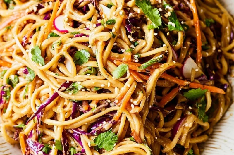 Asian noodle salad with colorful vegetables in peanut dressing