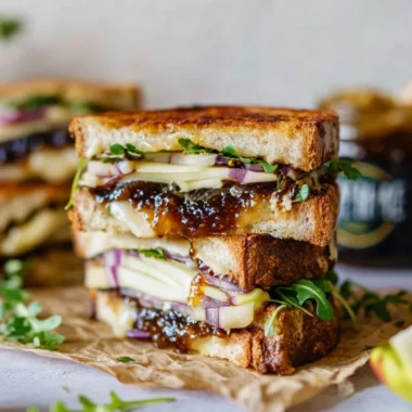 Brie, fig, and apple grilled cheese sandwich on a plate