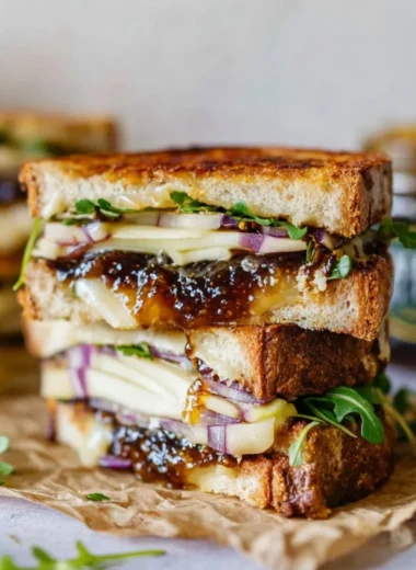 Brie, fig, and apple grilled cheese sandwich on a plate