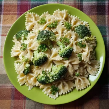 Creamy Broccoli Alfredo Pasta served in a bowl with a sprinkle of parmesan cheese.