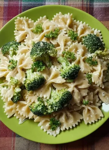 Creamy Broccoli Alfredo Pasta served in a bowl with a sprinkle of parmesan cheese.