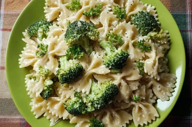Creamy Broccoli Alfredo Pasta served in a bowl with a sprinkle of parmesan cheese.
