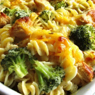 Cheesy broccoli chicken noodle casserole baked in a dish with golden cheese on top