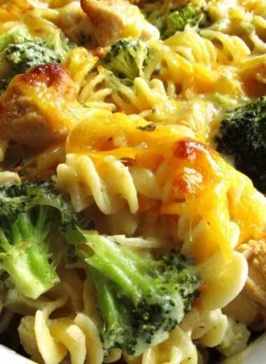 Cheesy broccoli chicken noodle casserole baked in a dish with golden cheese on top
