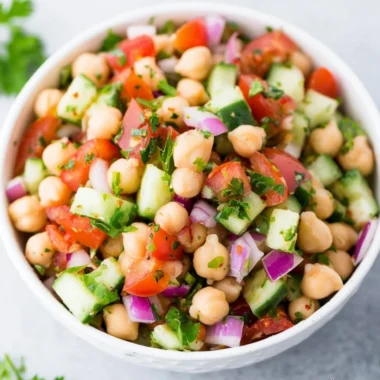 Colorful chickpea salad with fresh vegetables and herbs in a bowl