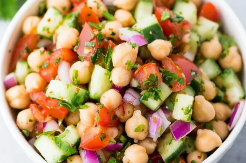 Colorful chickpea salad with fresh vegetables and herbs in a bowl