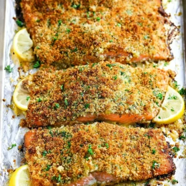 Crispy Garlic Parmesan Salmon fillet garnished with herbs on a plate.