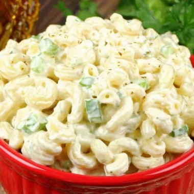 Bowl of deli-style macaroni salad with colorful vegetables and creamy dressing