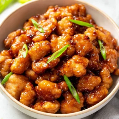 Delicious plate of honey butter chicken garnished with herbs
