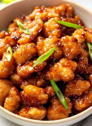 Delicious plate of honey butter chicken garnished with herbs