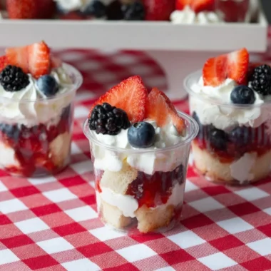 Delicious mini shortcake cups topped with fresh berries and whipped cream.