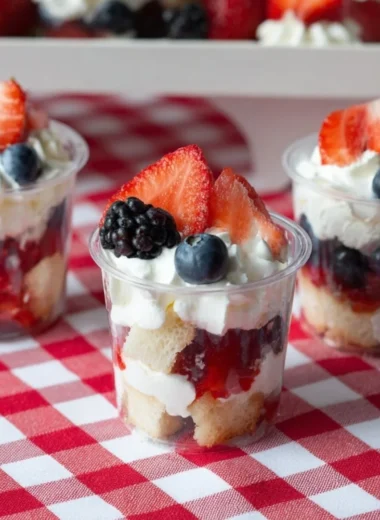 Delicious mini shortcake cups topped with fresh berries and whipped cream.