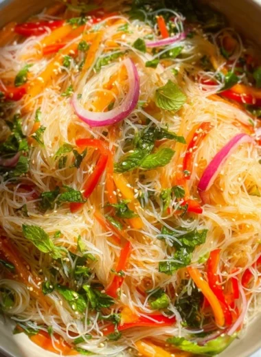 A delicious bowl of no cook noodle salad with colorful vegetables.