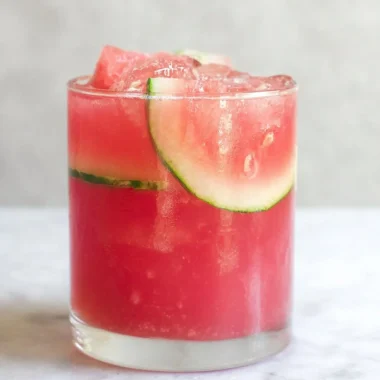 Refreshing watermelon cocktail punch served in glasses with fruit garnishes