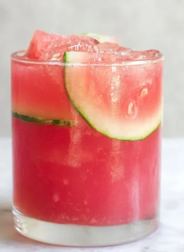 Refreshing watermelon cocktail punch served in glasses with fruit garnishes