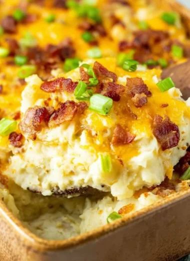 Delicious Twice Baked Potato Casserole topped with cheese and chives