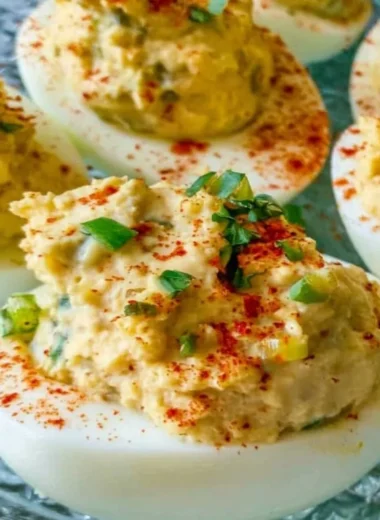 Cajun Deviled Eggs topped with spices and herbs on a serving platter