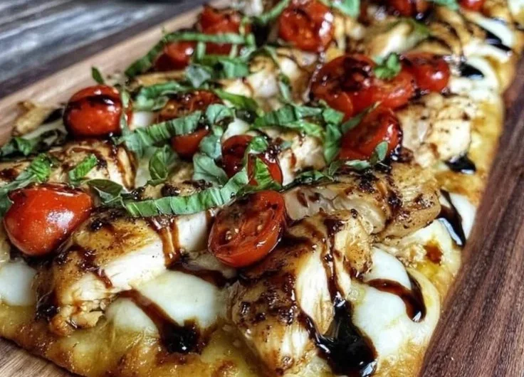 Delicious Chicken Caprese Flatbread topped with basil, mozzarella, and tomatoes