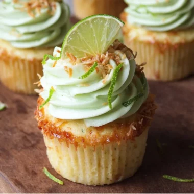 Delicious coconut cupcakes with lime buttercream frosting on a decorative plate