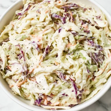 Delicious homemade coleslaw in a bowl with colorful cabbage and carrots