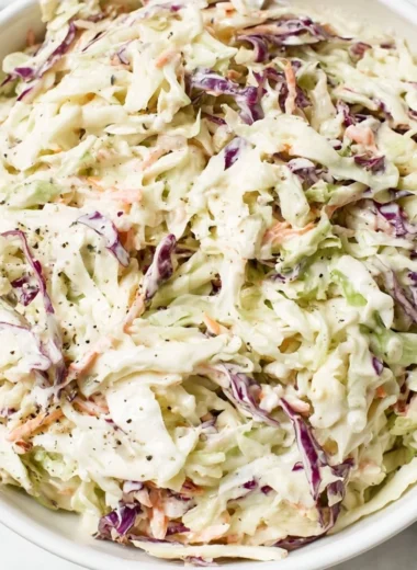 Delicious homemade coleslaw in a bowl with colorful cabbage and carrots