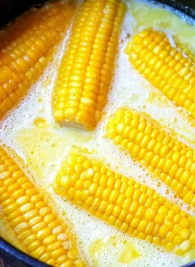 Freshly grilled corn on the cob served with butter and herbs