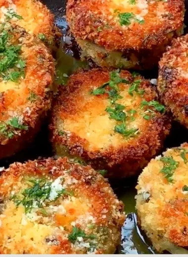 Plate of crispy breaded eggplant slices, golden brown and ready to serve