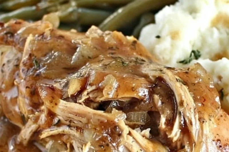 Delicious Crock Pot Mississippi Chicken served with sides on a rustic table