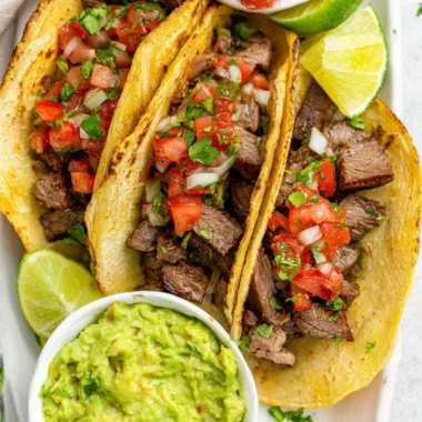 Delicious grilled beef tacos topped with fresh ingredients and cilantro