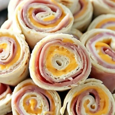 Plate of ham and cheese roll-ups served as a delicious snack or appetizer