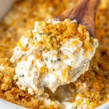 Delicious Million Dollar Chicken Casserole topped with cheese and herbs.