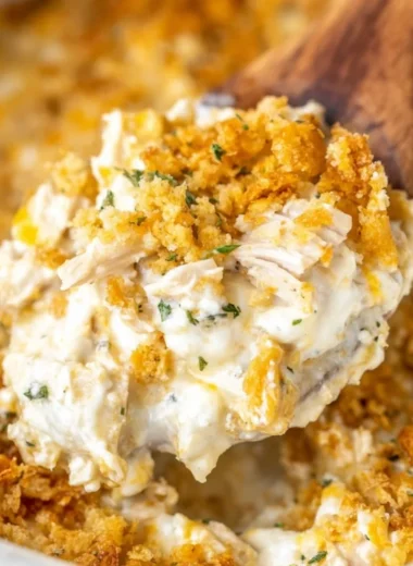 Delicious Million Dollar Chicken Casserole topped with cheese and herbs.