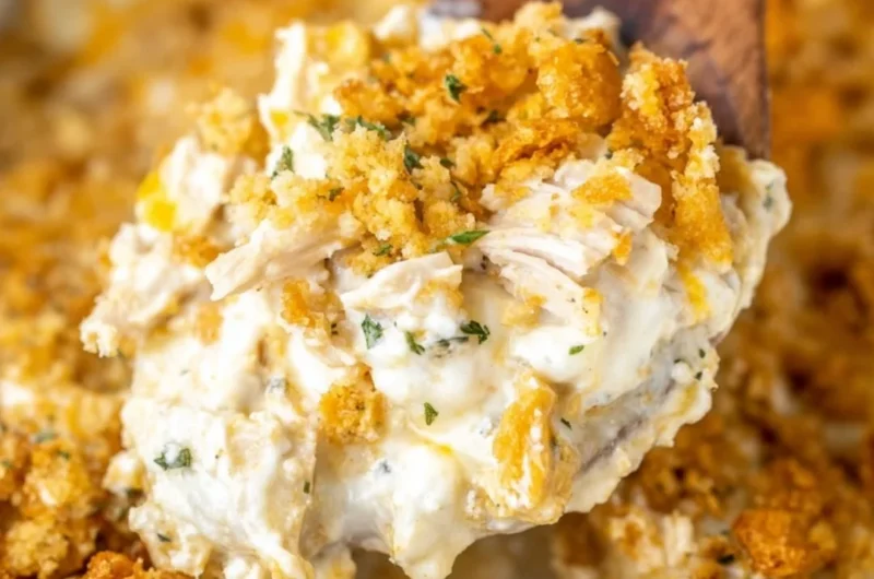 Delicious Million Dollar Chicken Casserole topped with cheese and herbs.