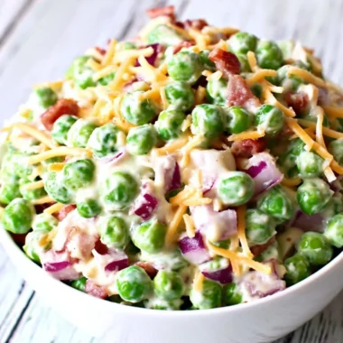 Delicious pea salad with red onions and cheese in a bowl.
