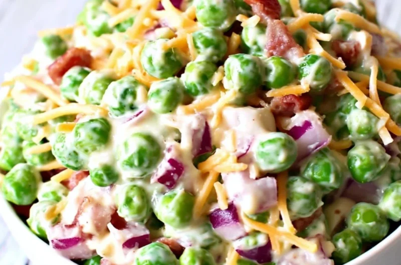 Delicious pea salad with red onions and cheese in a bowl.