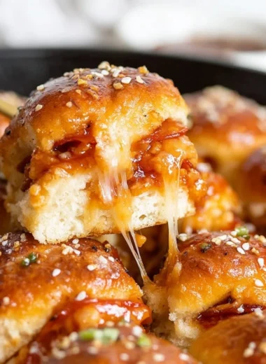 Delicious pizza sliders served on a platter with toppings.