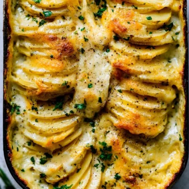 Deliciously creamy scalloped potatoes layered with cheese and herbs