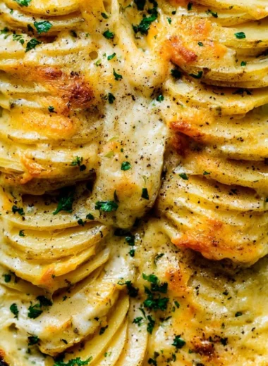 Deliciously creamy scalloped potatoes layered with cheese and herbs
