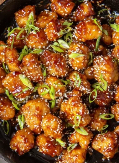 Delicious plate of sesame chicken with sesame seeds and vegetables
