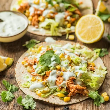 Skinny buffalo chicken tacos served in a vibrant dish with toppings