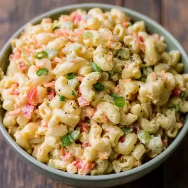 Bowl of small homemade macaroni salad with vegetables and dressing