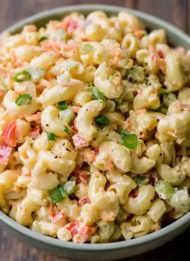 Bowl of small homemade macaroni salad with vegetables and dressing