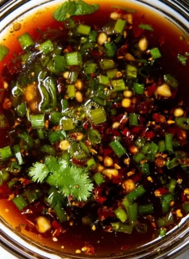 Delicious homemade spring roll sauce in a dipping bowl with fresh spring rolls.