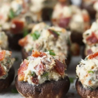 Stuffed mushrooms with bacon, cream cheese, and green onions on a serving platter